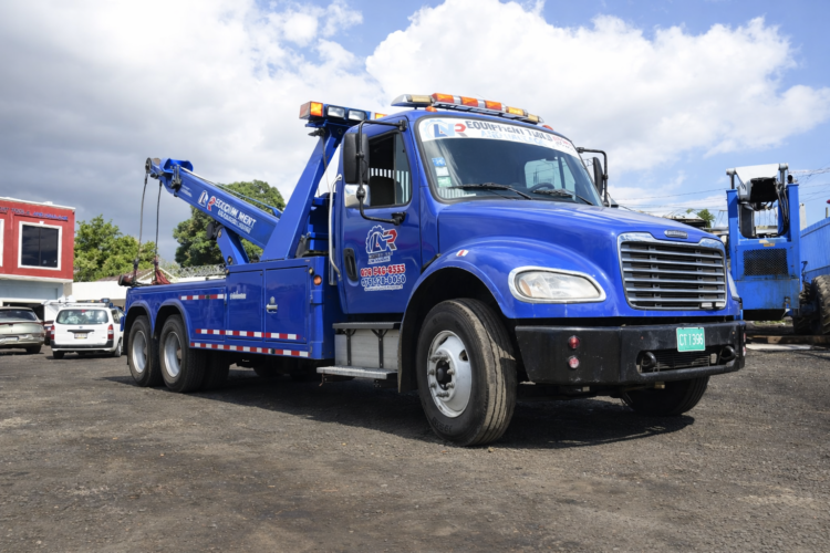 Blue wrecker truck in daytime lot